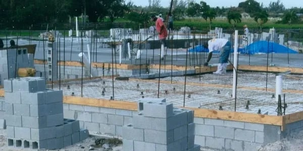 Andros Roofing Construction employees working on the building's foundation